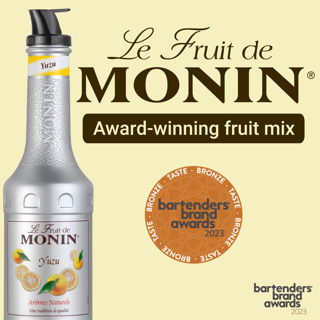 An image of a MONIN fruit mix bottle labeled "Le Fruit de MONIN Yuzu" on a light yellow background. The text reads "Le Fruit de MONIN, Award-winning fruit mix." There is a bronze medallion for the Bartenders Brand Awards 2023 to the right of the bottle, highlighting its perfect blend for refreshing citrus fruit lemonades.